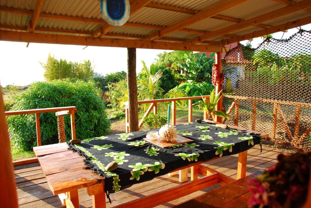 a table and a bench on a patio at Cabañas Moai in Hanga Roa