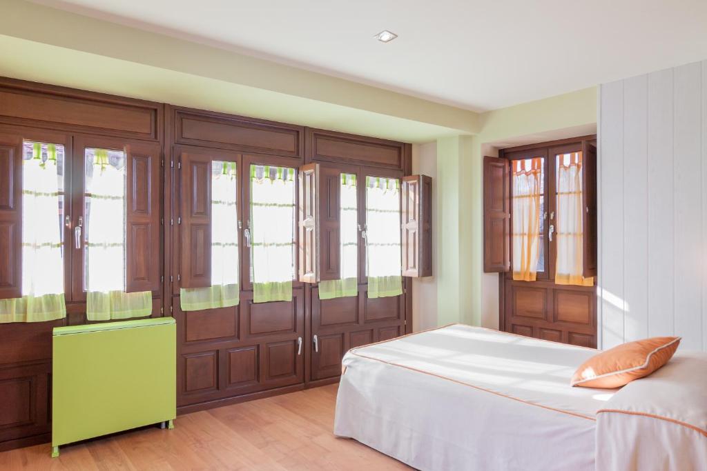 A bed or beds in a room at Apartamentos Santana