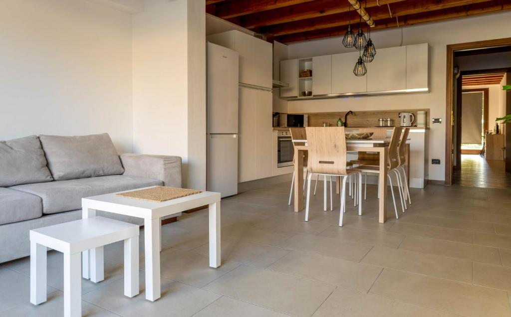 a living room with a couch and a table and chairs at Ca' Linda By Case al Lago in Desenzano del Garda