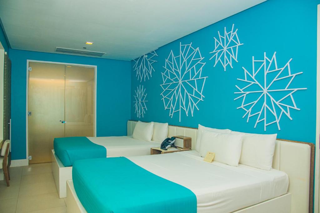 Postel nebo postele na pokoji v ubytování Astoria Boracay