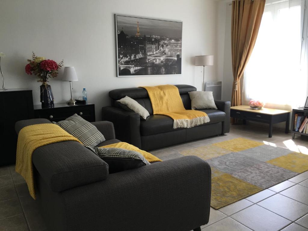 a living room with a couch and a couch and a table at F&B's Home Disneyland Paris in Serris