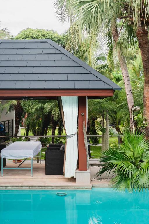 a gazebo next to a swimming pool at Villa Banyak | Luxury 4Br villa with nice terrace and personal playground in Ban Saiyuan (1)