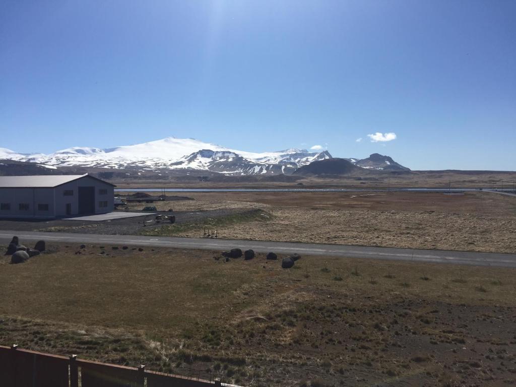 a view of a road and snow covered mountains at North Star Apartments Rif in Snæfellsbær