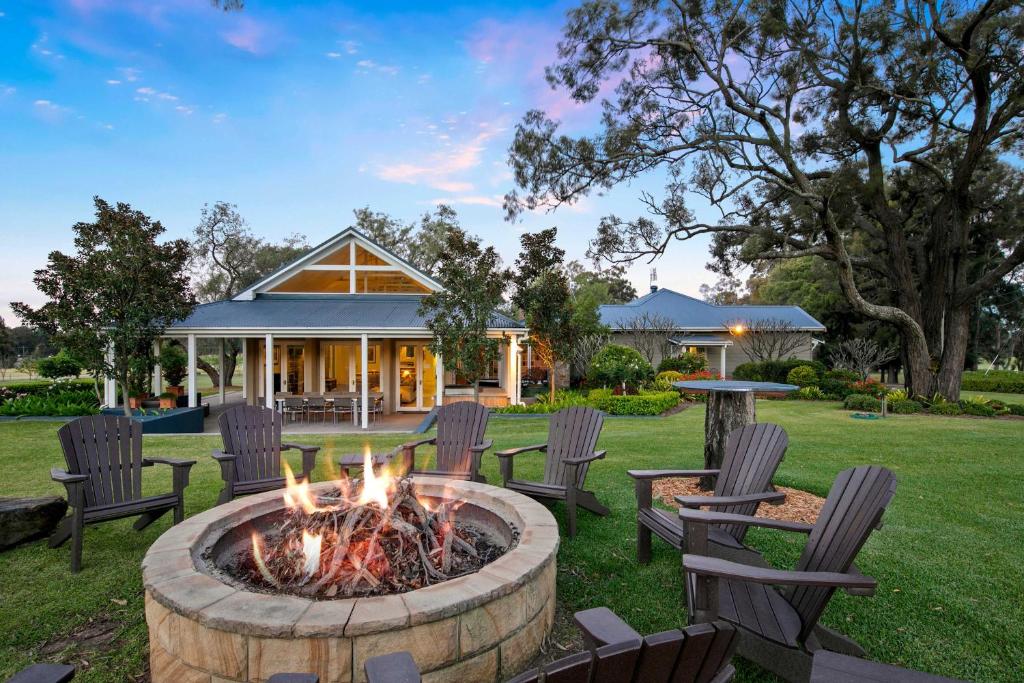 a fire pit in the yard of a house at Brokenback Vineyard Homestead in Pokolbin