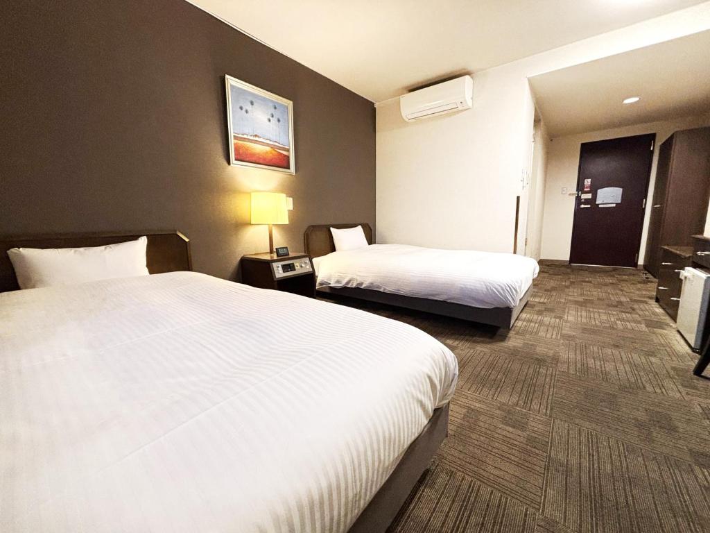 Postel nebo postele na pokoji v ubytování Hotel Route-Inn Ageo