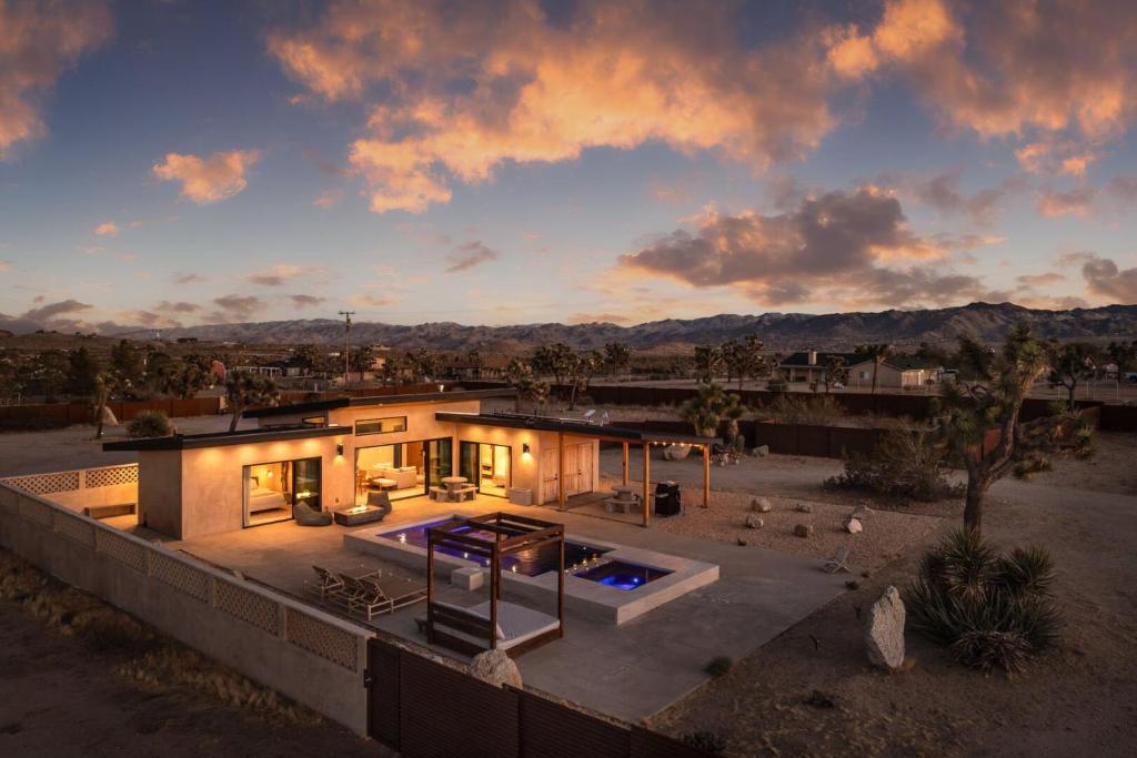 a house with a swimming pool in the yard at Sol e Cielo Casa Dua by Fieldtrip in Yucca Valley