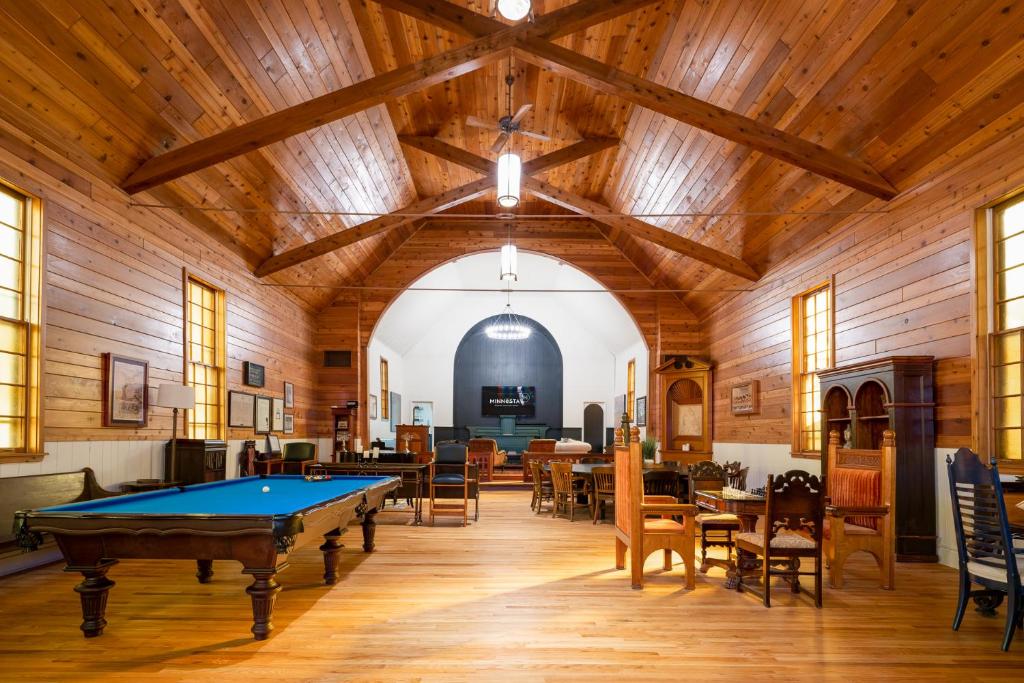 a pool table in a room with wooden ceilings at Lyndale Church Lodge in Minneapolis
