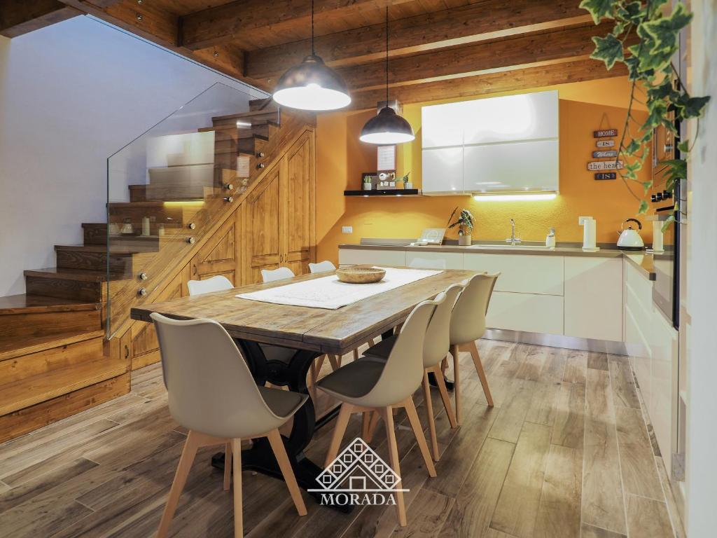 a kitchen with a wooden table and chairs at Domu Mea - MORADA in Iglesias