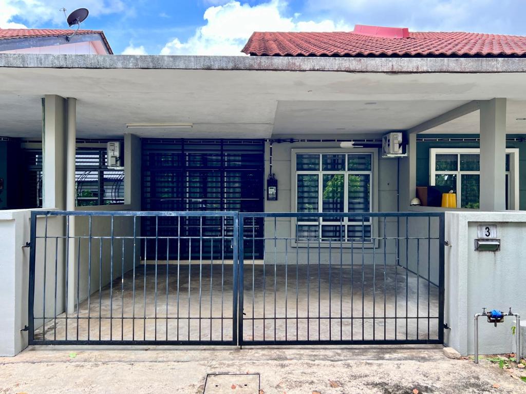 a gate in front of a house at Casa Damai Kuantan - near Taman Tas, SEMSAS, UMP,Airport, Uia, Matrik Gambang, Menara 188, 4bilik-3AC 1kipas, Ruang Tamu kipas in Kuantan