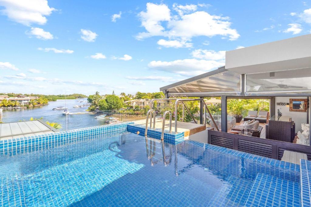 a swimming pool with a view of a river at Zodiac Penthouse - Sea & Mountain in Rivière Noire