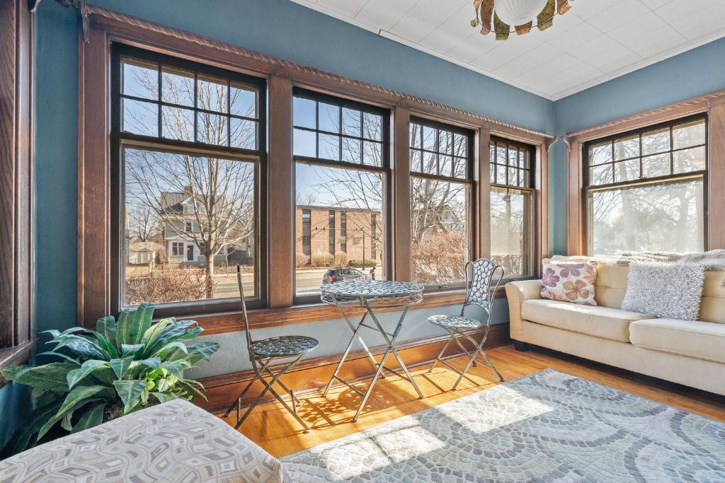 a living room with a couch and windows at Uptown Urban Living in Minneapolis