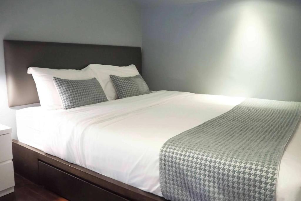 a bedroom with a large white bed with two pillows at Heritage Collection on Boon Tat in Singapore