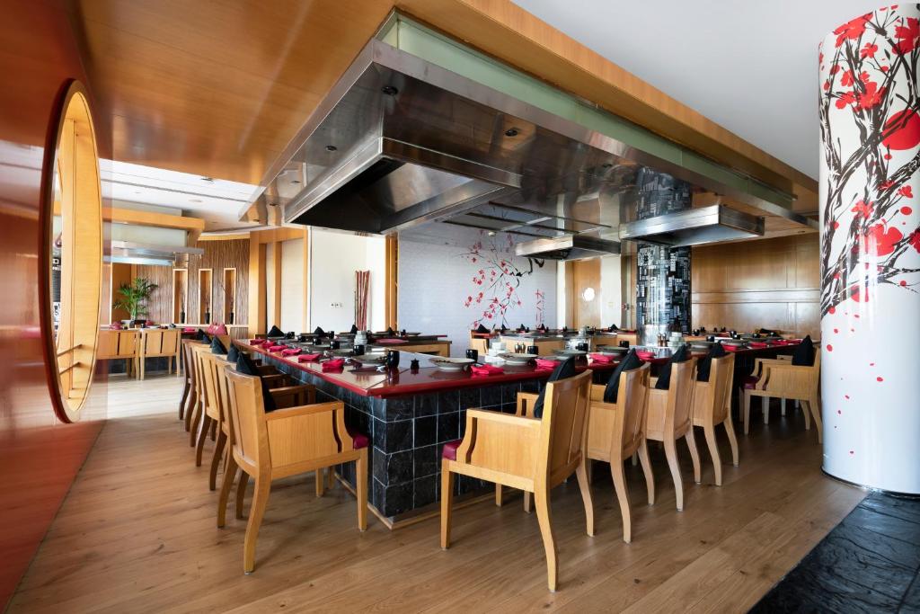 a large dining room with a long table and chairs at Beach Rotana - Abu Dhabi in Abu Dhabi