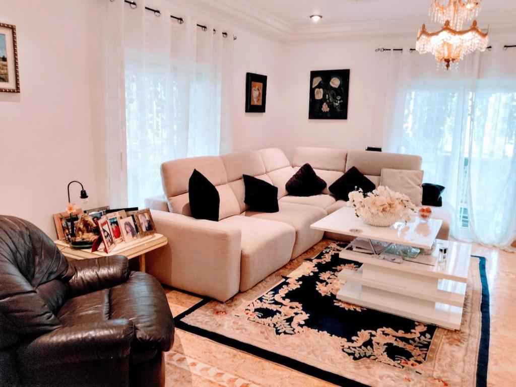 a living room with a couch and a table at Villa lujo Elche in Asprillas