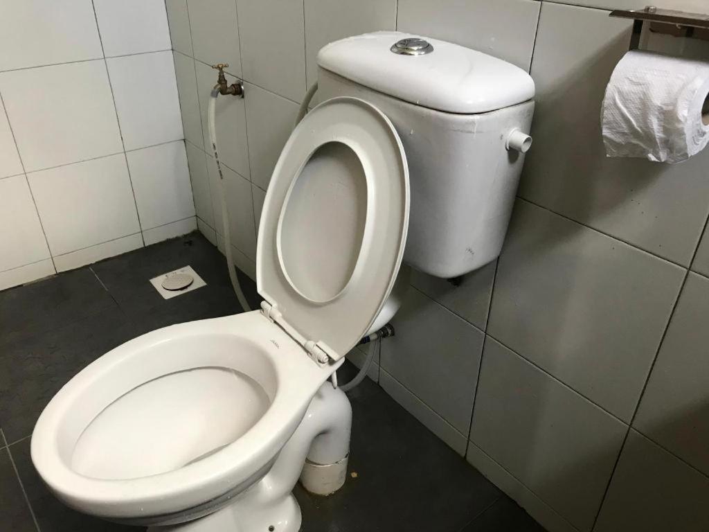 a bathroom with a white toilet in a stall at VIVA HOTEL SRI AMAN in Simanggang
