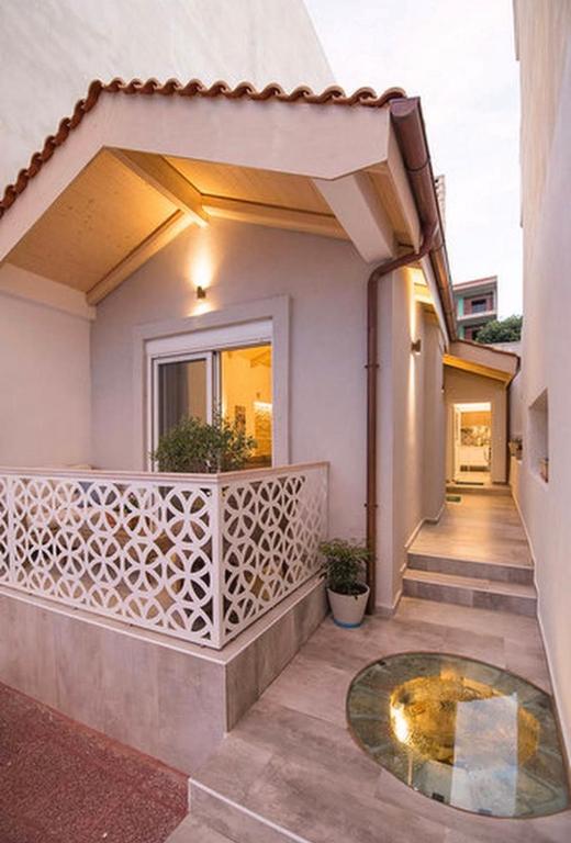 a balcony of a house with a table at Carezza Apartments in Preveza