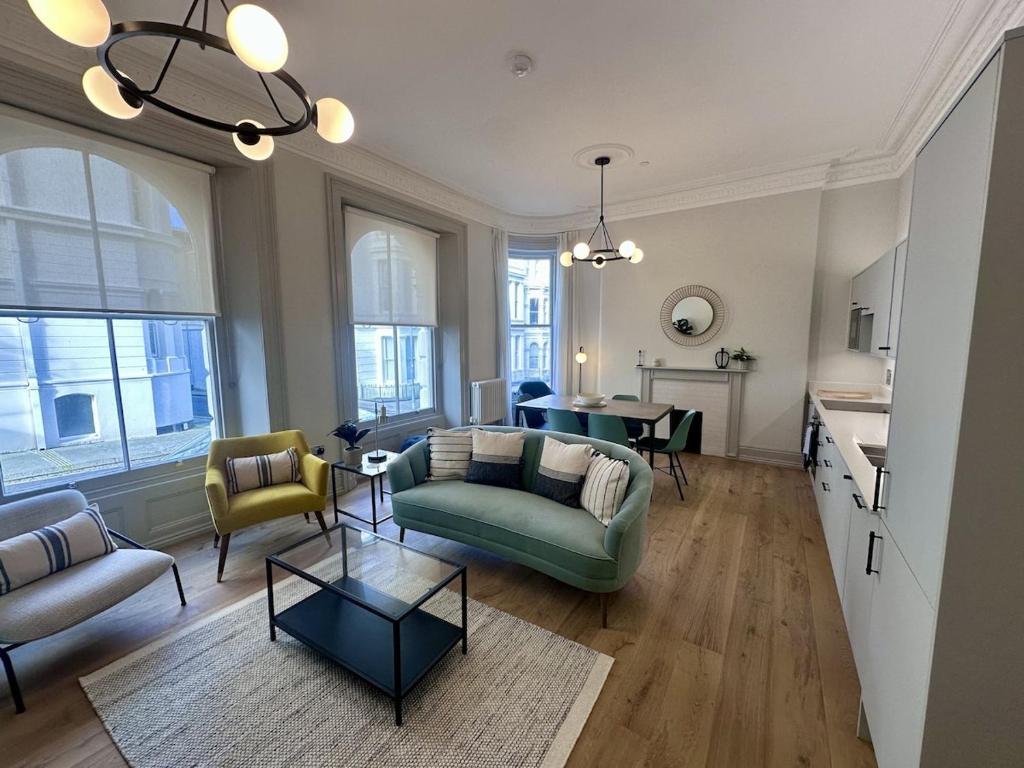 a living room with a couch and a table at Halliford By Pureserviced in Plymouth