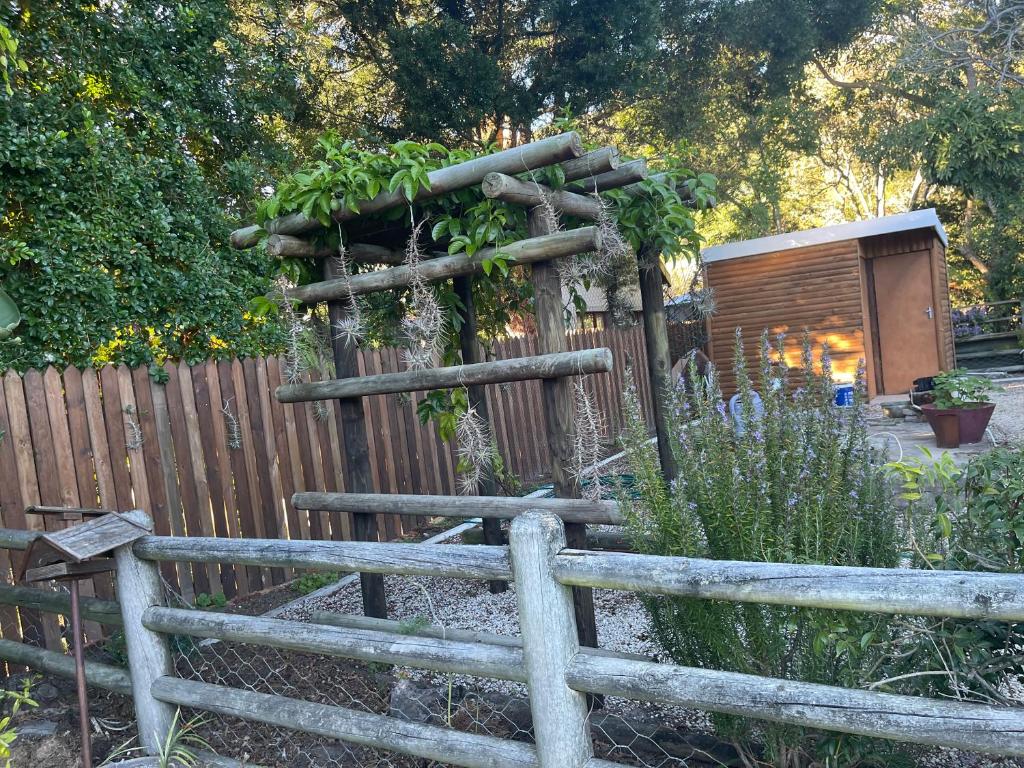 a wooden fence with plants on top of it at Knysna's Rest in Brenton-on-Sea