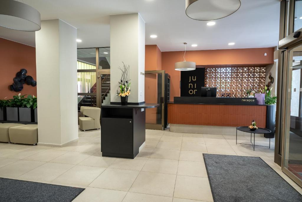 a lobby of a hotel with a waiting area at Hotel Junior Poděbrady in Poděbrady