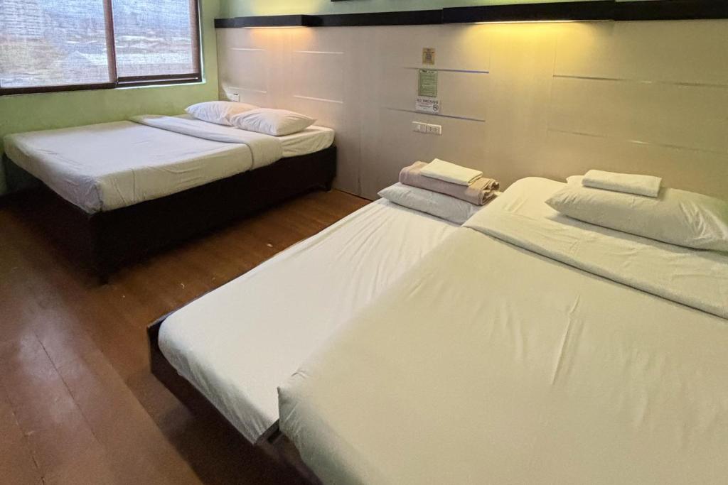 Postel nebo postele na pokoji v ubytování Sugbutel Family Hotel Cebu powered by Cocotel