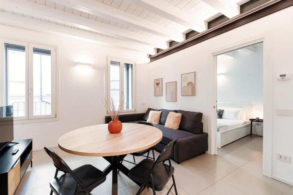 a living room with a table and a couch at Como Lago Apartment by Quokka 360 - Close to the Lake and Train Station in Como