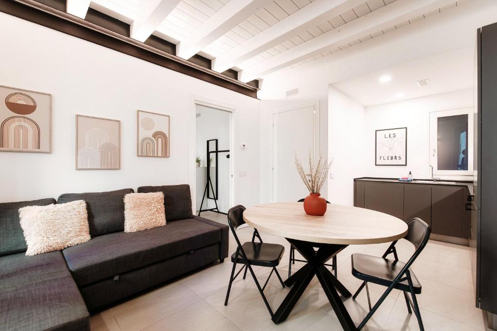 a living room with a couch and a table at Como Lago Apartment by Quokka 360 - Close to the Lake and Train Station in Como