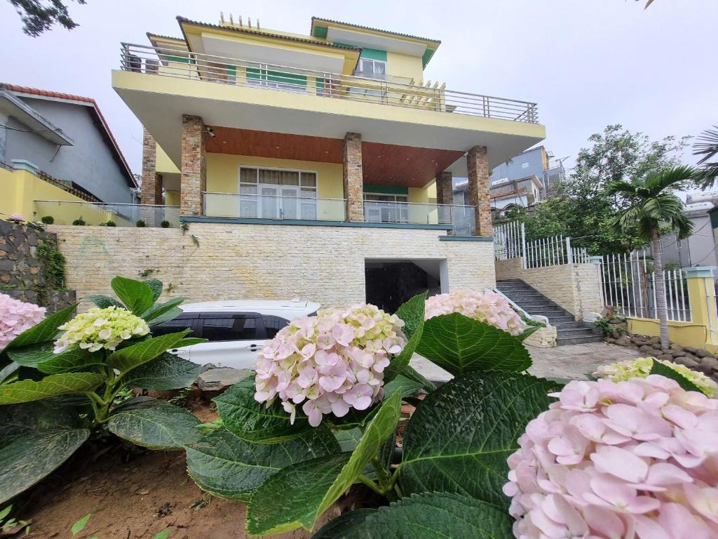 a house with pink flowers in front of it at Top Hill Halong in Ha Long