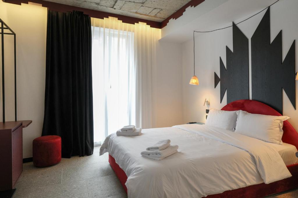 Postel nebo postele na pokoji v ubytování Bazaar Hotel
