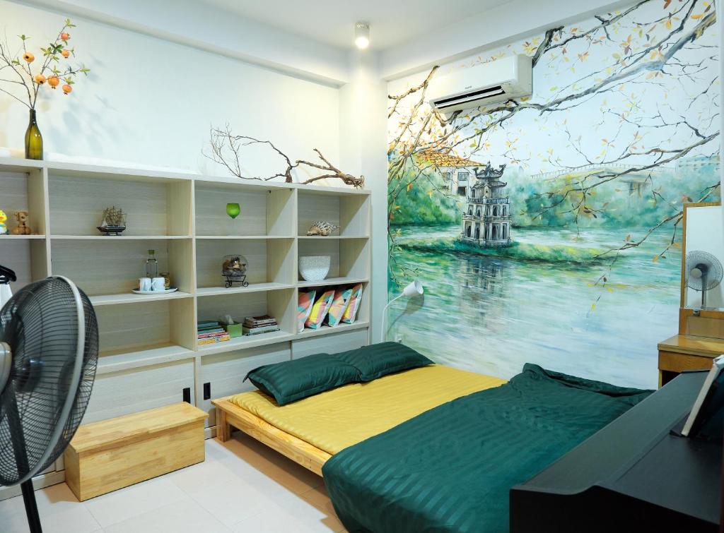 a bedroom with a bed and a painting on the wall at Huong's Homestay in Ho Chi Minh City