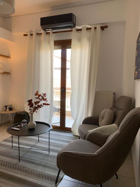 a living room with a couch and a table at Aelin Living in Agrinion