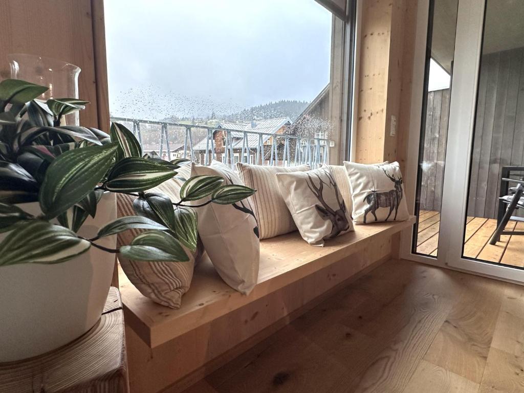 a living room with a couch and a large window at AllgäuLiebe in Oberstaufen