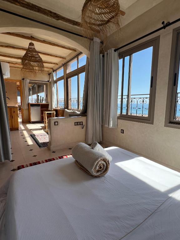 a bedroom with a bed with a towel on it at SurfAppart Morocco in Tamraght Ouzdar
