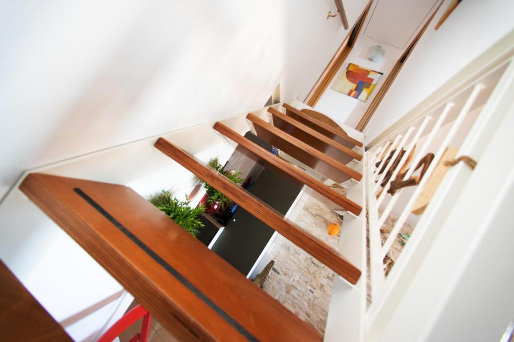 a stairway with wooden railings in a house at Dimora Rubino - Isola di Pellestrina Ve in Pellestrina