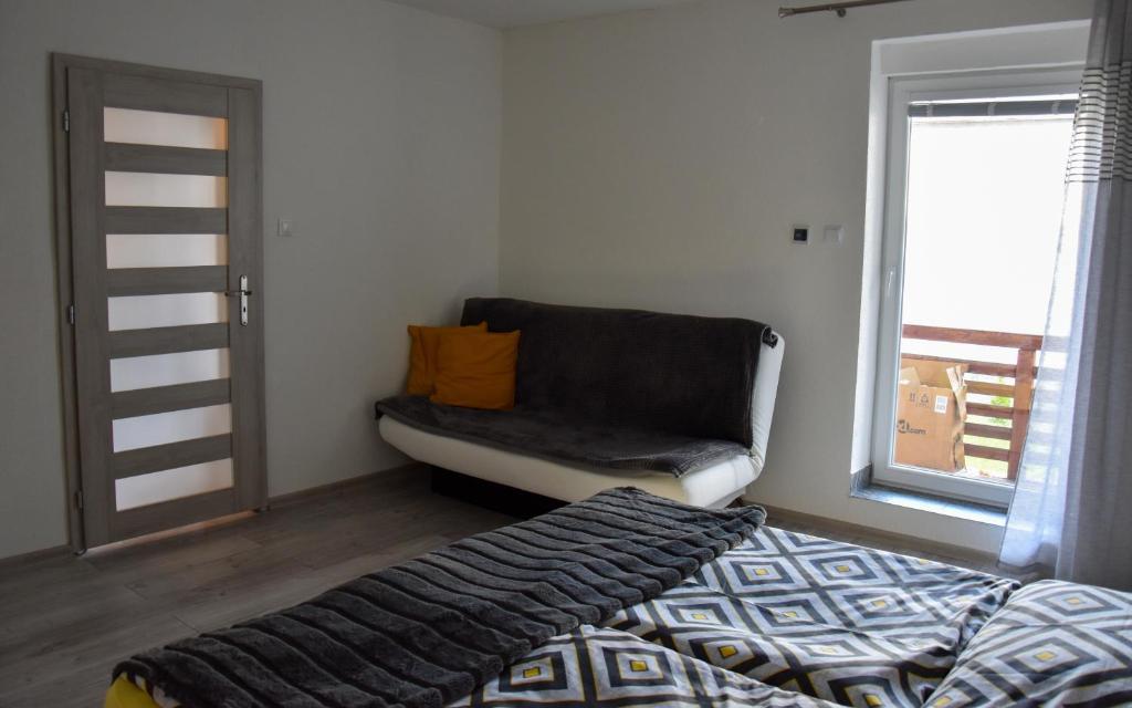 A bed or beds in a room at Apartmán u Braňa