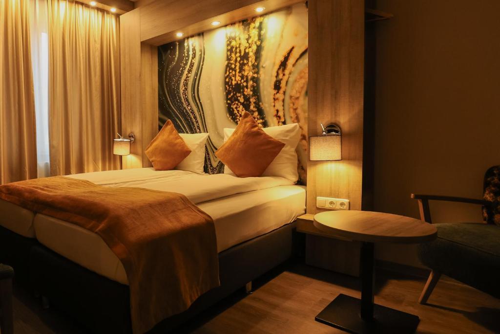 Postel nebo postele na pokoji v ubytování Liebig-Hotel