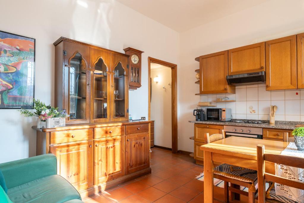a kitchen with wooden cabinets and a wooden table at Traveler's Retreat in Lecco in Lecco