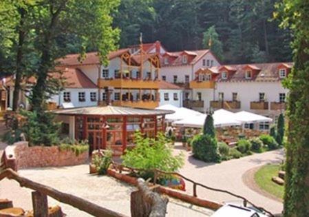 a large white building with a resort in the background at Schlosshotel Landstuhl in Landstuhl