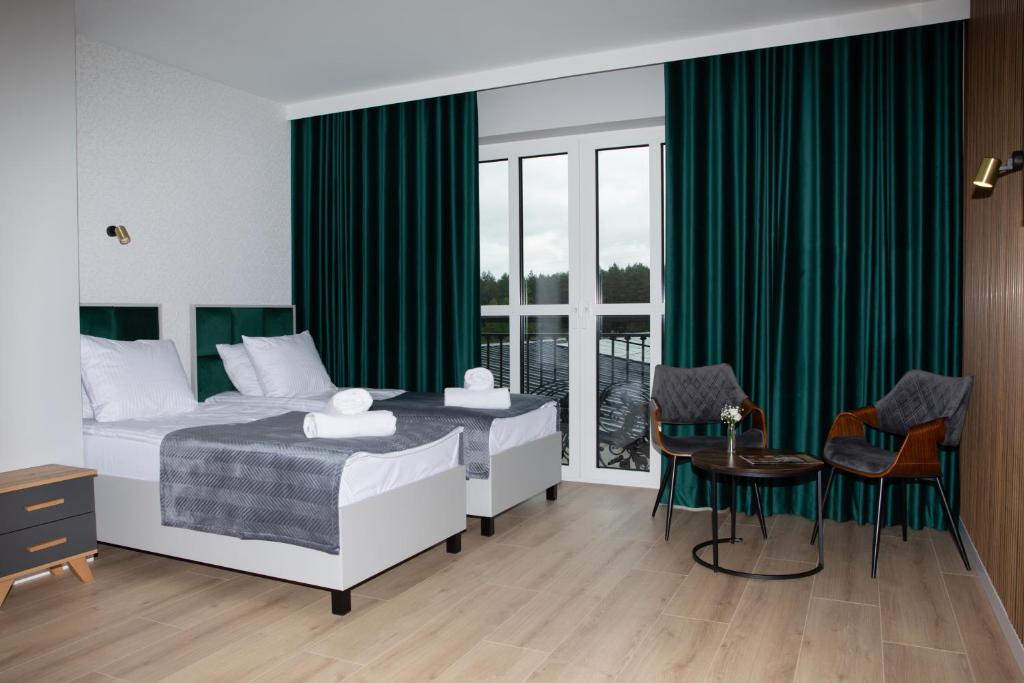 Postel nebo postele na pokoji v ubytování Wisteria Hotel