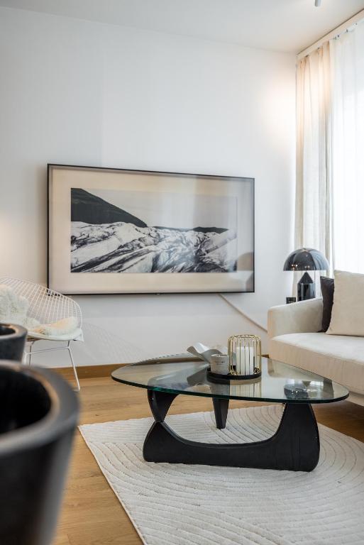 a living room with a coffee table and a couch at Scandinavian Deluxe House With Private Sauna at Kamppi in Helsinki