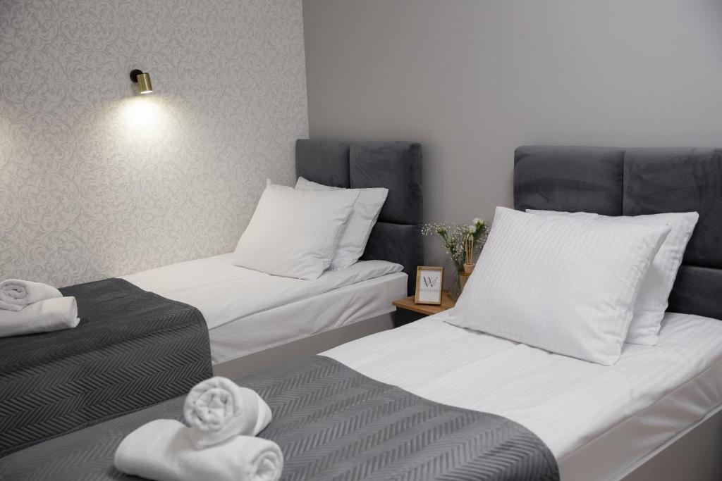 Postel nebo postele na pokoji v ubytování Wisteria Hotel