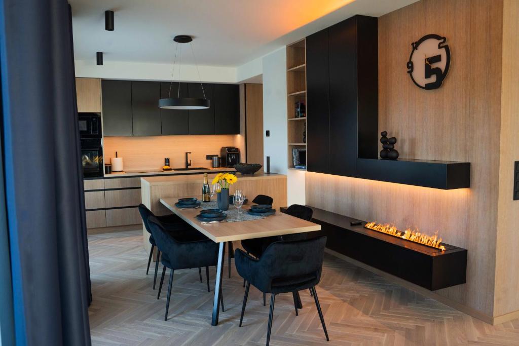 a kitchen and dining room with a table and chairs at Lux Penthouse with sauna in Rakvere