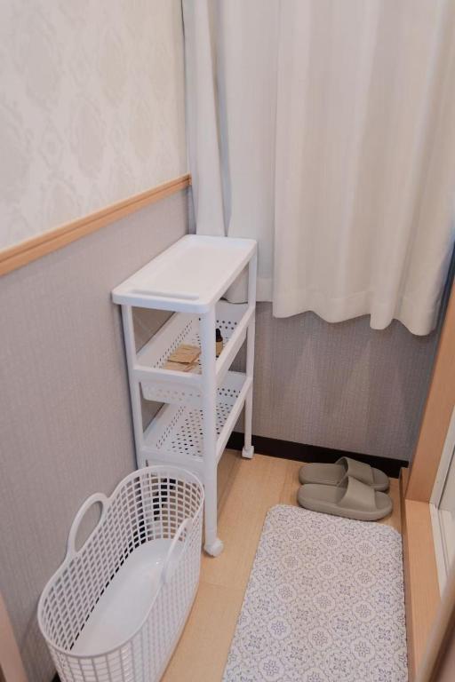 Postel nebo postele na pokoji v ubytování 桜の宿