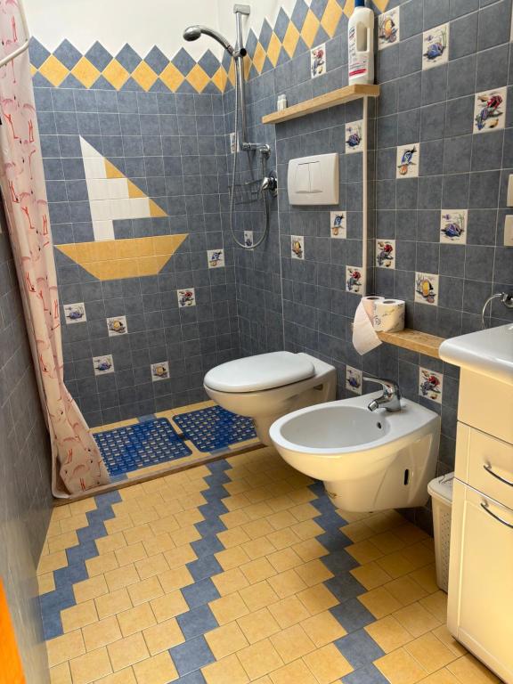 a bathroom with a shower and a toilet and a sink at Appartamento Nuvola Bianca 2 in Cesenatico