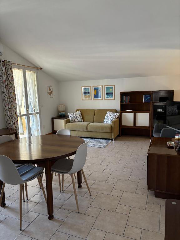 a living room with a table and a couch at Appartamento Nuvola Bianca 2 in Cesenatico