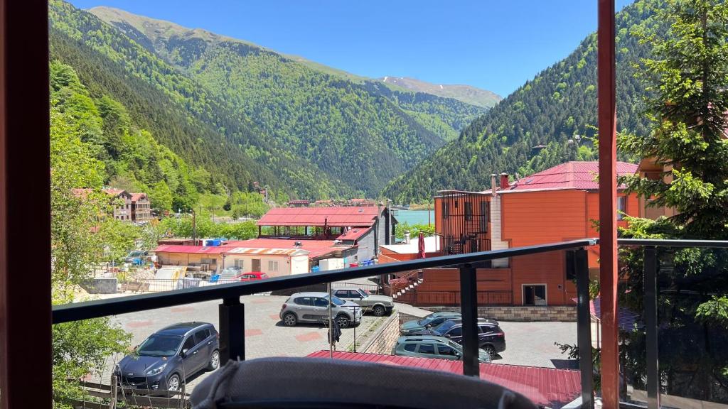 a balcony with a view of a parking lot and mountains at Lavera Home Uzungöl in Uzungöl