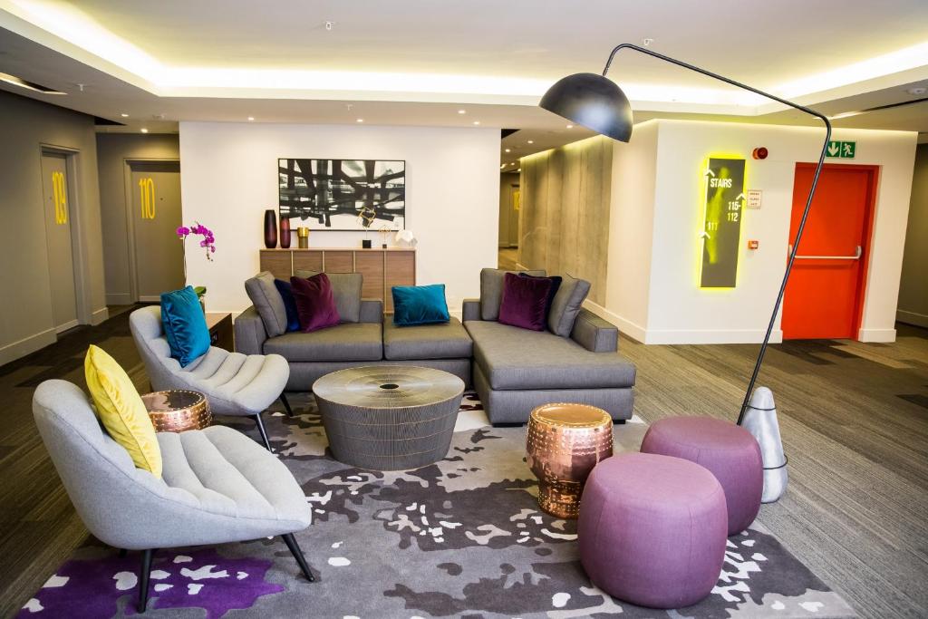 a living room filled with furniture and a couch at The Capital Mirage in Cape Town