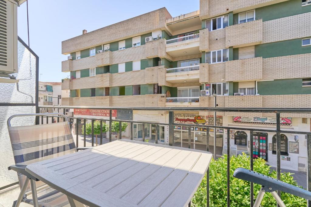 a wooden bench sitting on the balcony of a building at Apartmento Calle Antonio Millón in Nerja