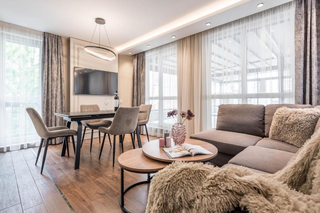 a living room with a couch and a table at City Center Luxury Apartments in Varna City