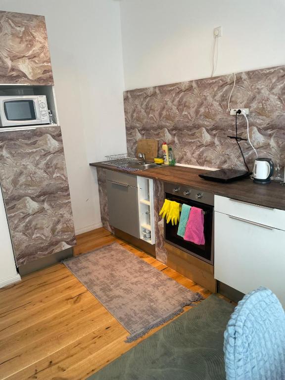 a kitchen with a counter top and a stove at AVIZJA Living in Korneuburg