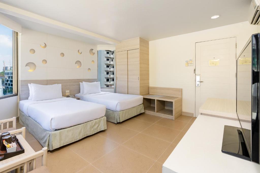 Postel nebo postele na pokoji v ubytování Sunshine Hotel & Residences